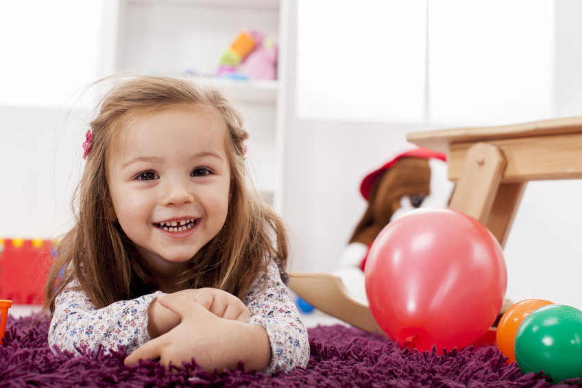 Girl on floor with balloons