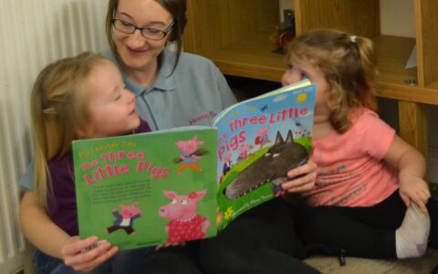 Reading together at Happy Kids Clifton, day nursery, Rotherham